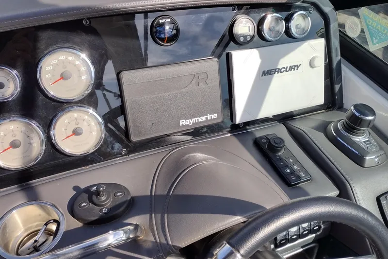 Slide: The Image of 2019 Formula 310 Bowrider dashboard with gauges, Raymarine, and Mercury controls. - 15