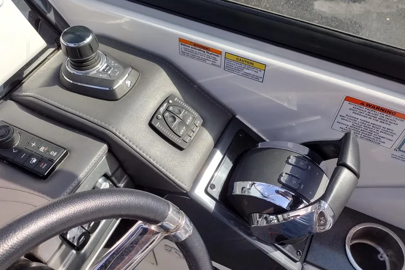 Slide: The Image of 2019 Formula 310 Bowrider cockpit controls with joystick and throttle levers. - 16