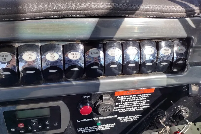 Slide: The Image of Control panel of a 2019 Formula 310 Bowrider boat with labeled switches and warning labels. - 17
