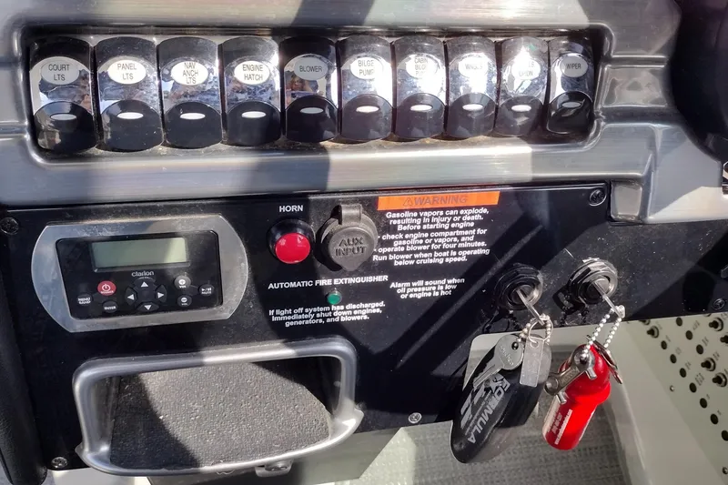 Slide: The Image of Control panel of a 2019 Formula 310 Bowrider boat with switches and ignition keys. - 18
