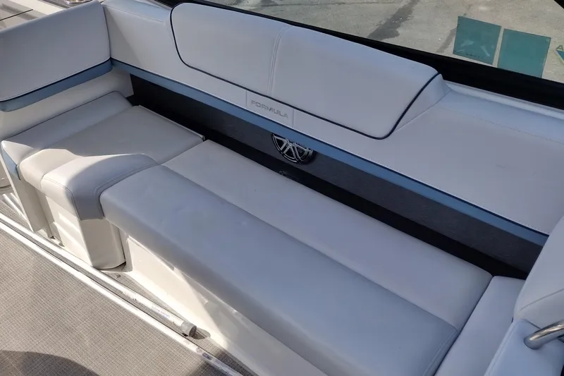 Slide: The Image of 2019 Formula 310 Bowrider interior seating with white upholstery and sleek design. - 24