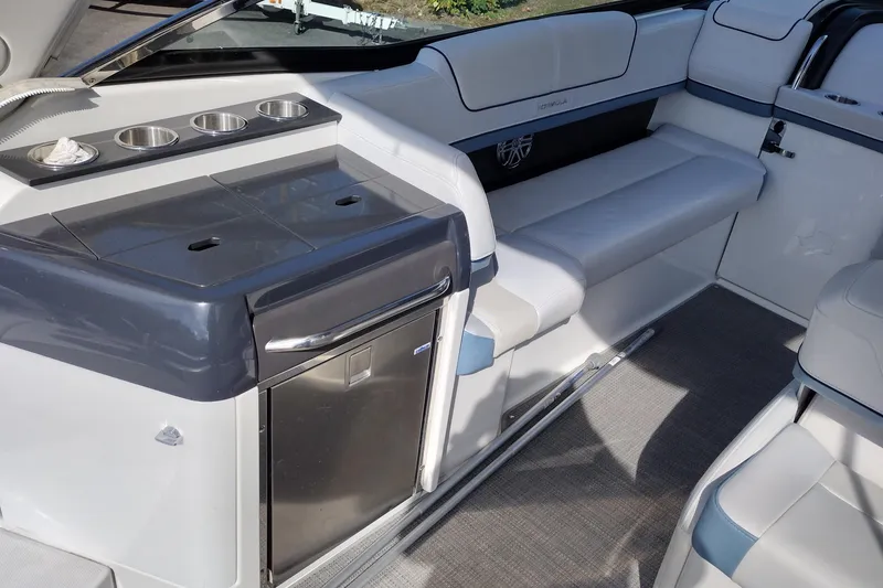 Slide: The Image of 2019 Formula 310 Bowrider interior with seating, cup holders, and mini fridge. - 25