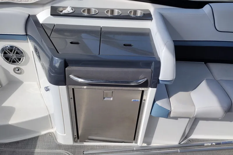 Slide: The Image of 2019 Formula 310 Bowrider interior with seating, cup holders, and built-in cooler. - 26