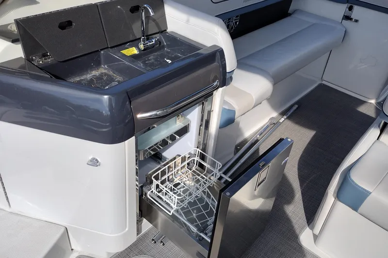 Slide: The Image of 2019 Formula 310 Bowrider interior with open drawer and seating area. - 27