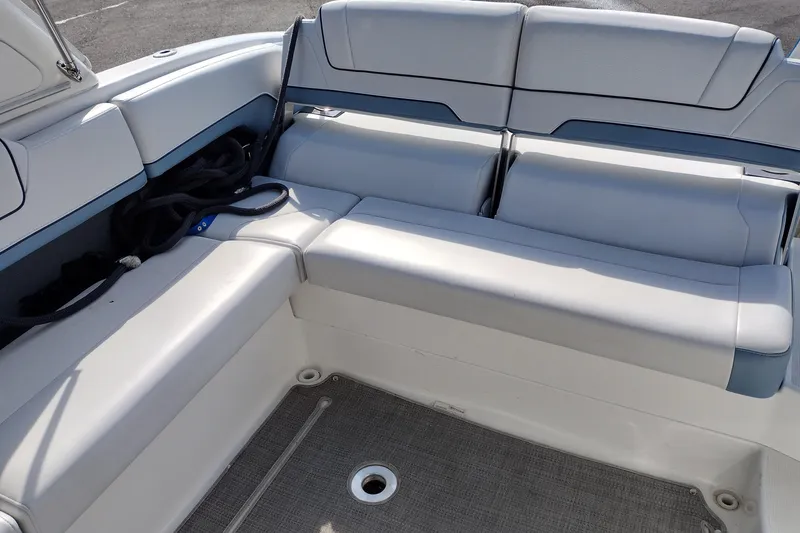 Slide: The Image of 2019 Formula 310 Bowrider interior seating with light gray upholstery and storage space. - 28