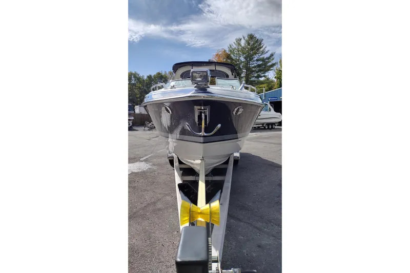 Slide: The Image of 2019 Formula 310 Bowrider on trailer, parked outdoors under a partly cloudy sky. - 3