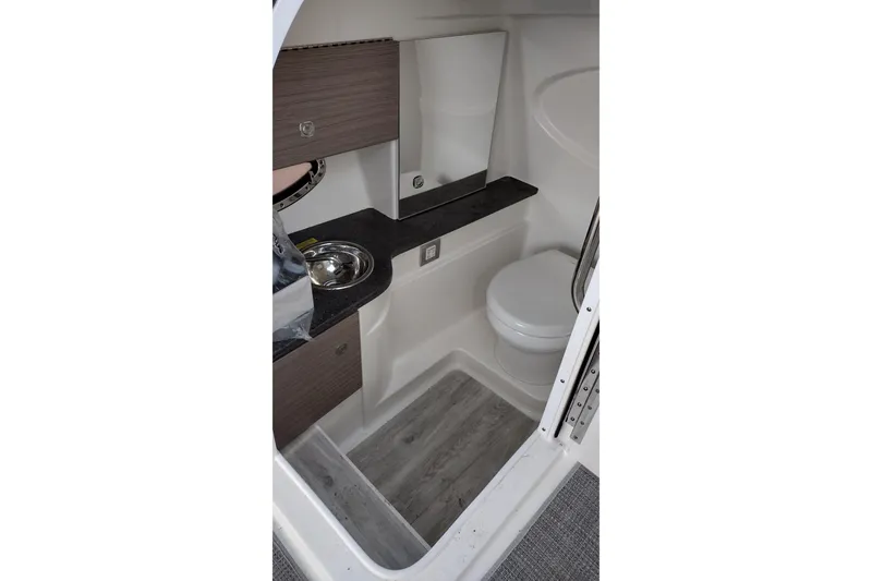 Slide: The Image of 2019 Formula 310 Bowrider interior bathroom with sink, toilet, and wood accents. - 30