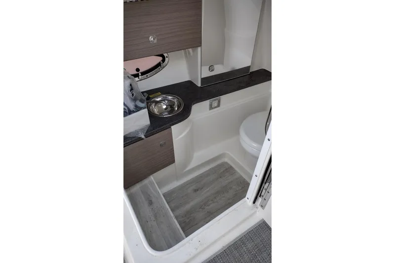 Slide: The Image of 2019 Formula 310 Bowrider interior with sink, toilet, and modern cabinetry. - 32