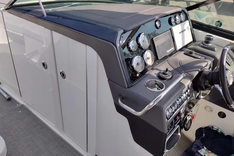 Slide: The Image of 2019 Formula 310 Bowrider dashboard with modern controls and sleek design. - 49