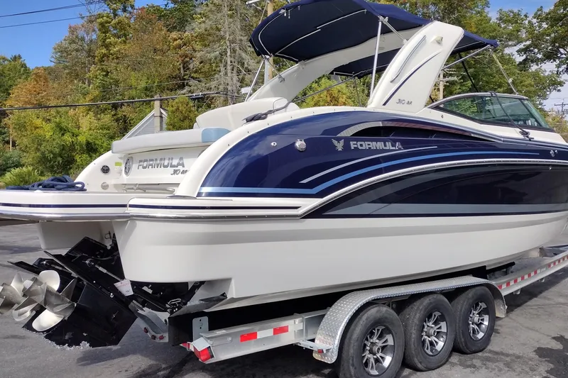 Slide: The Image of 2019 Formula 310 Bowrider boat on trailer, featuring sleek design and dual propellers. - 6