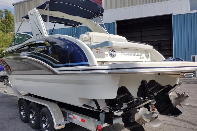Slide: The Image of 2019 Formula 310 Bowrider boat on trailer, featuring sleek design and dual propellers. - 7