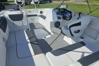 Slide: The Image of 2024 Tahoe 2150 boat interior with modern seating and steering console. - 10