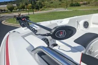 Slide: The Image of 2024 Tahoe 2150 boat with trolling motor on deck, scenic background. - 12