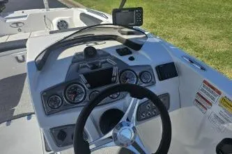 Slide: The Image of 2024 Tahoe 2150 boat dashboard with steering wheel and navigation system. - 3