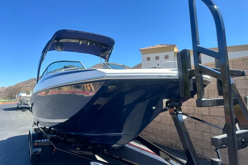 Slide: The Image of 2012 Regal 24 FasDeck boat interior with beige and white seating. - 10