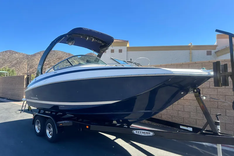 Slide: The Image of 2012 Regal 24 FasDeck boat interior with beige and white seating. - 11