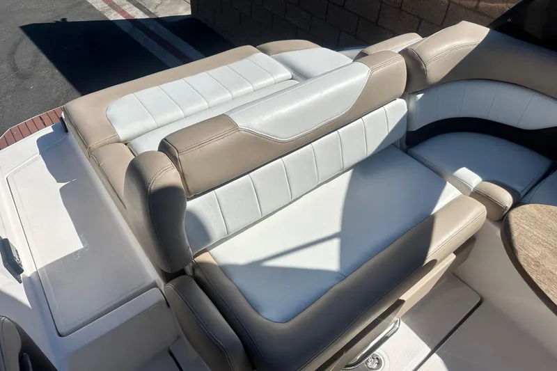 Slide: The Image of 2012 Regal 24 FasDeck boat interior with beige and white seating. - 14