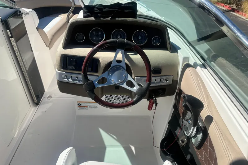 Slide: The Image of 2012 Regal 24 FasDeck boat interior with cup holders and metal fixtures. - 17