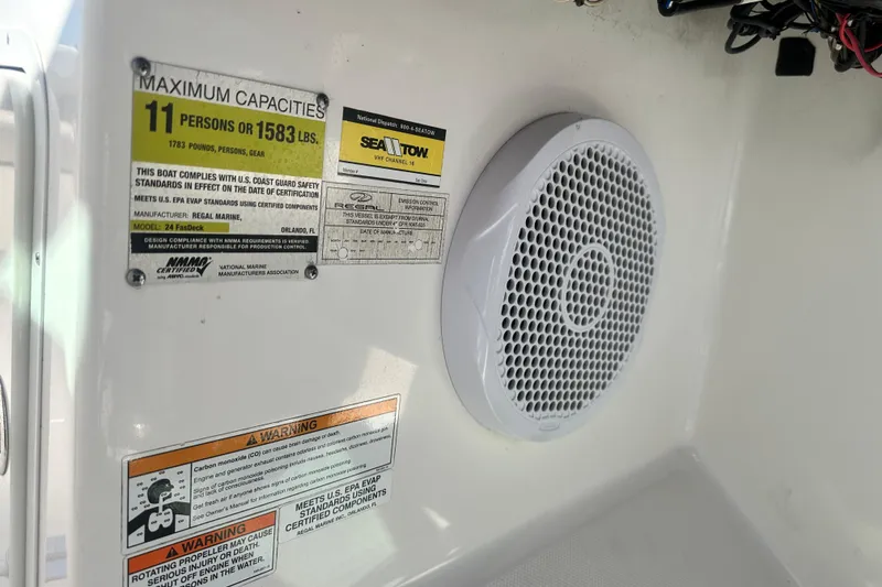 Slide: The Image of 2012 Regal 24 FasDeck boat cockpit with steering wheel and dashboard controls. - 19