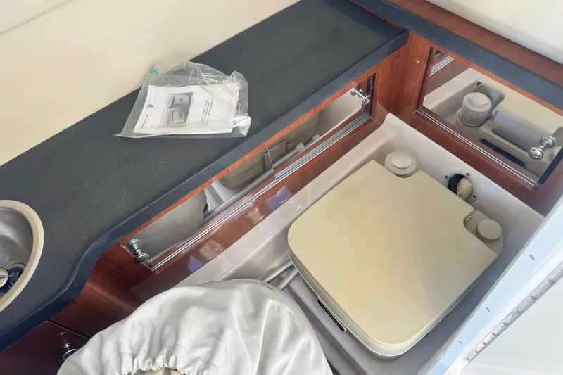 Slide: The Image of 2012 Regal 24 FasDeck boat cockpit with steering wheel and white captain's seat. - 20