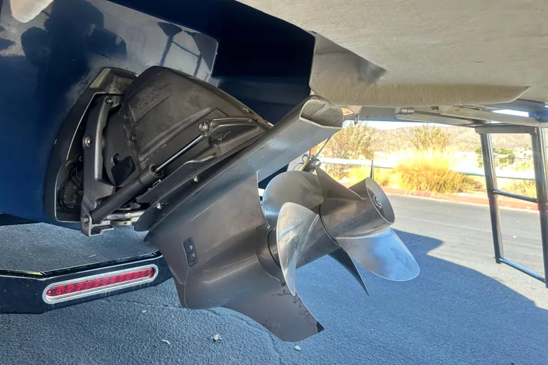 Slide: The Image of 2012 Regal 24 FasDeck boat on trailer, rear view, parked outdoors. - 5