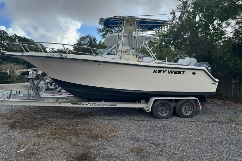 Slide: The Image of 2005 Key West 225 Center Console boat on trailer, parked outdoors. - 10