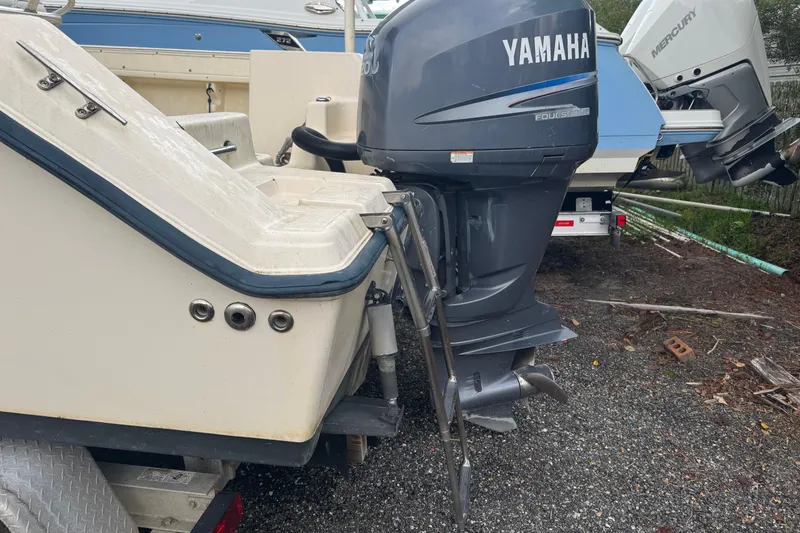 Slide: The Image of 2005 Key West 225 Center Console with Yamaha outboard motor, parked on gravel. - 13