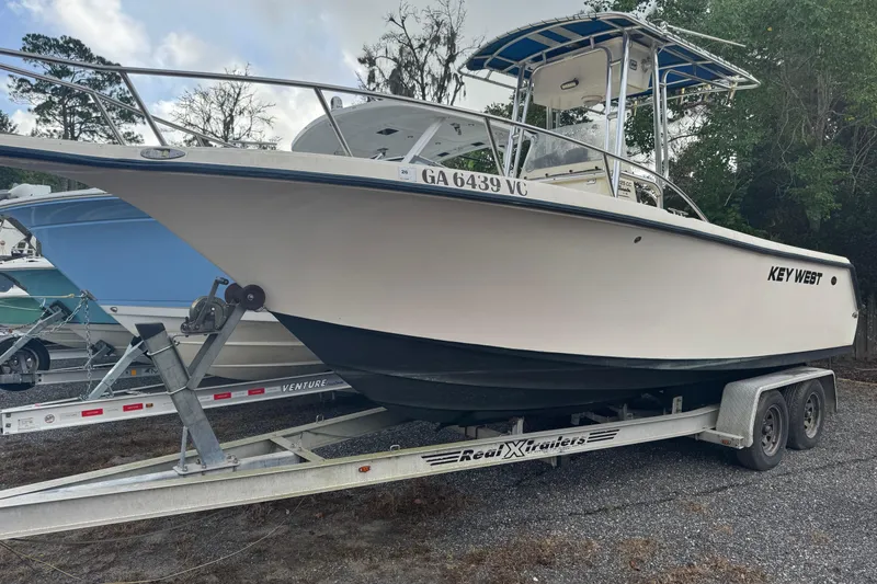 The Image of 2005 Key West 225 Center Console boat on trailer, parked outdoors. - 6