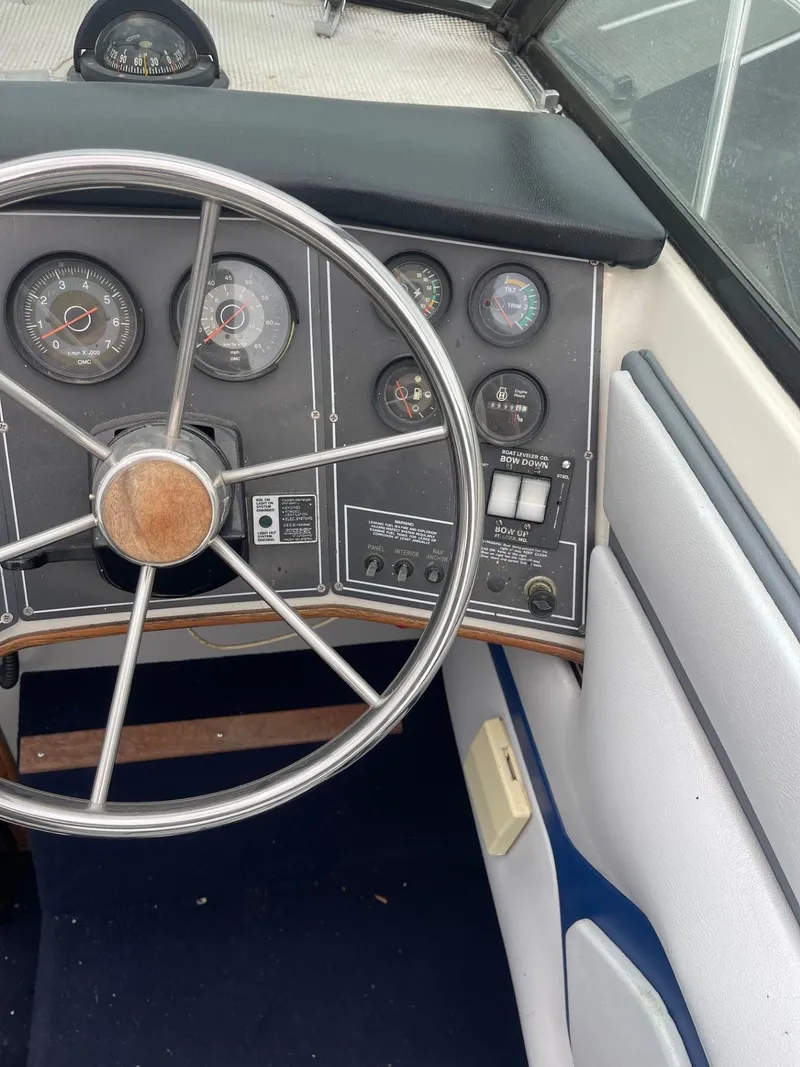 Slide: The Image of 1988 Regal boat dashboard with steering wheel and gauges. - 11