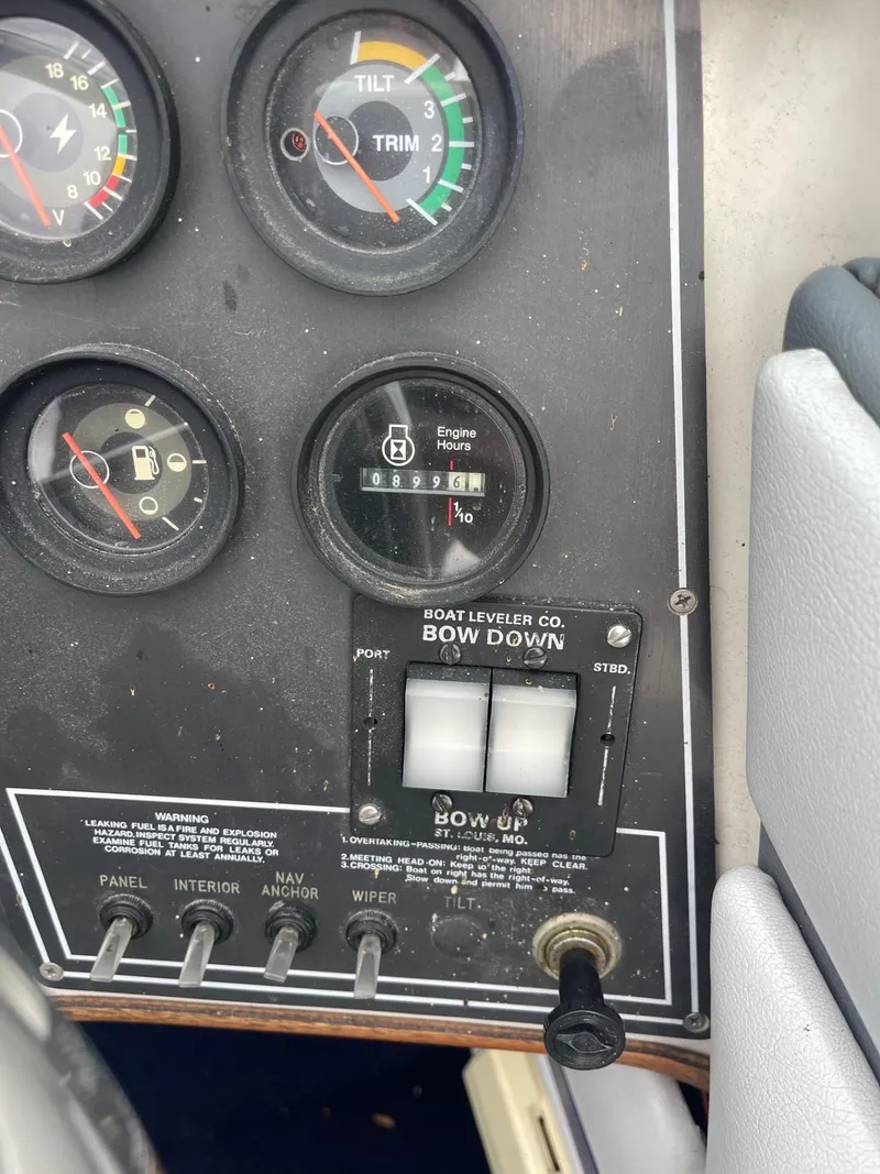 Slide: The Image of 1988 Regal boat dashboard with gauges and controls, including trim and bow leveler. - 12