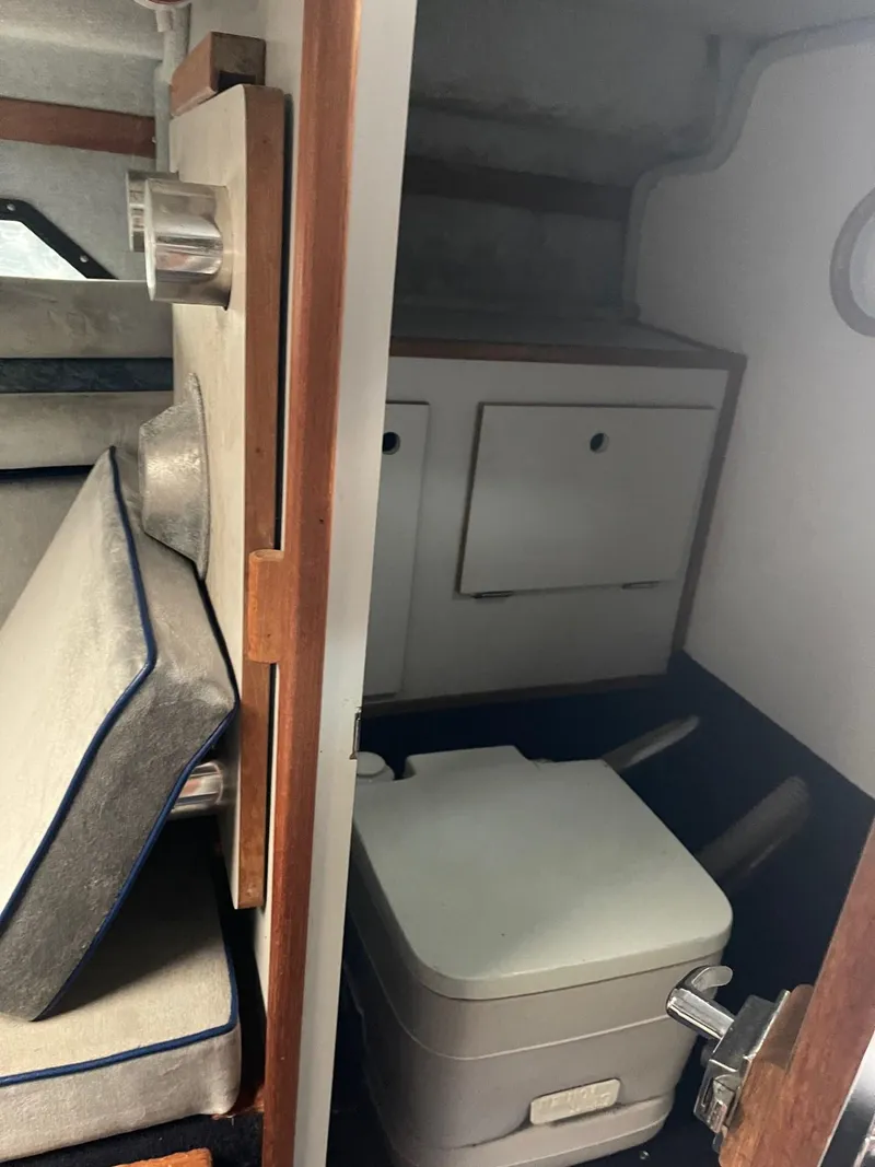 Slide: The Image of 1988 Regal boat interior with compact toilet and storage cabinets. - 13
