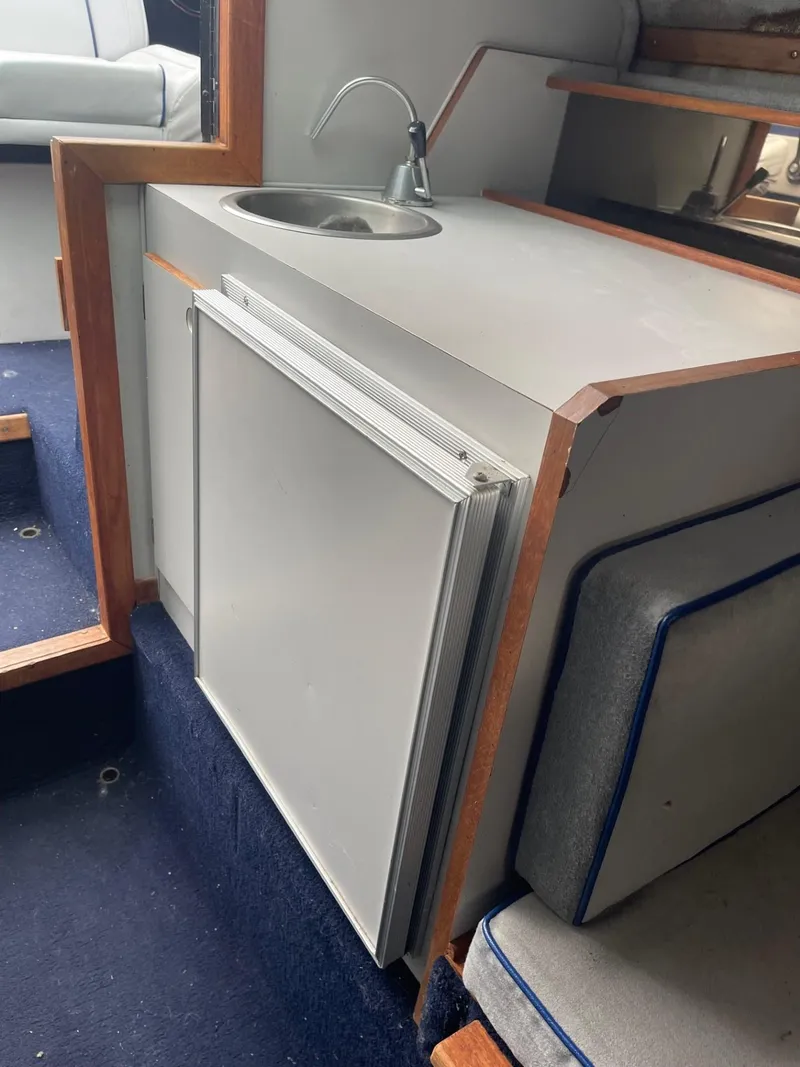 Slide: The Image of 1988 Regal boat kitchenette with sink and mini fridge. - 15