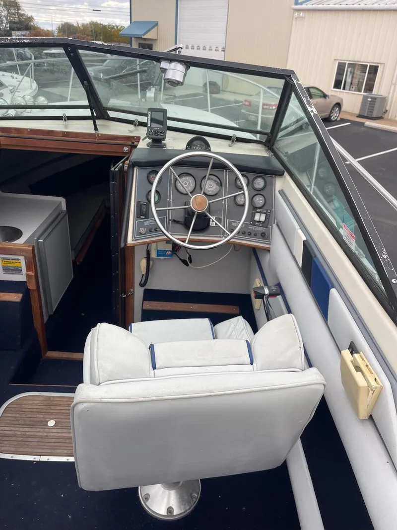 Slide: The Image of 1988 Regal boat interior with steering wheel and dashboard, featuring classic design elements. - 7