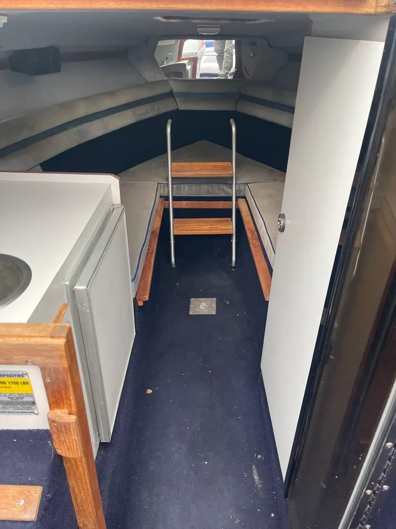 Slide: The Image of Interior of a 1988 Regal REGAL boat cabin with seating and storage. - 9
