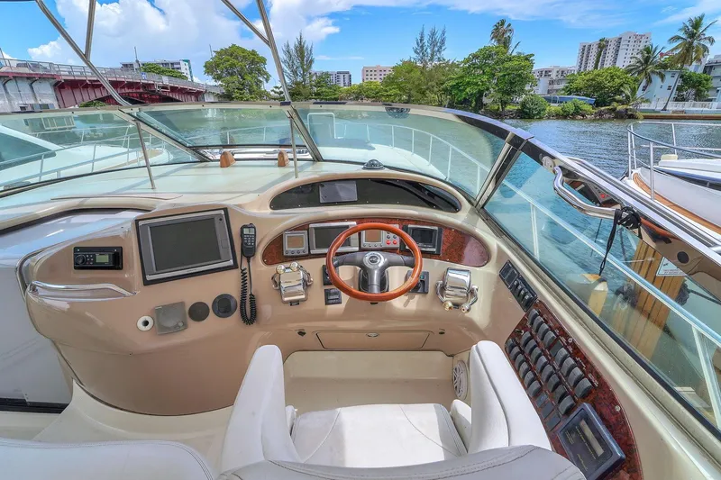 Slide: The Image of 2004 Sea Ray 460 Sundancer helm with steering wheel, controls, and navigation equipment. - 13