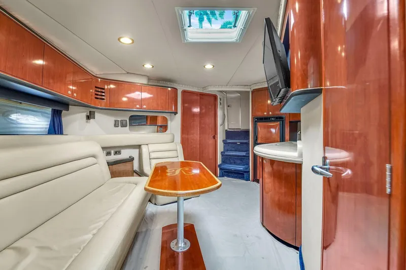 Slide: The Image of Luxurious interior of 2004 Sea Ray 460 Sundancer yacht with plush seating and wood finishes. - 16