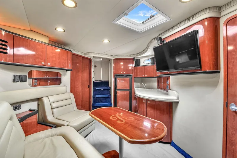 Slide: The Image of Luxurious interior of 2004 Sea Ray 460 Sundancer yacht with leather seating and wood finishes. - 17