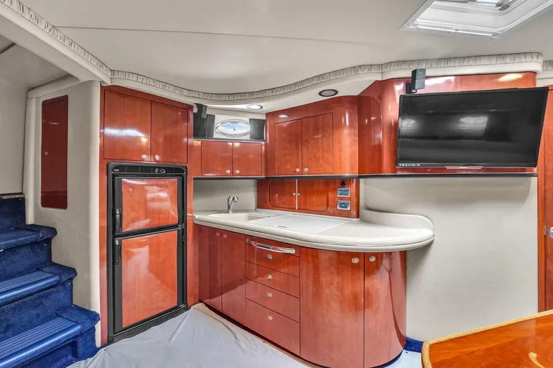 Slide: The Image of Luxurious 2004 Sea Ray 460 Sundancer yacht interior with modern kitchen and TV. - 18