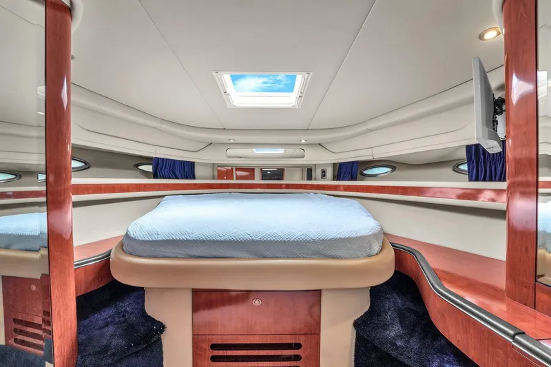 Slide: The Image of Luxurious cabin interior of 2004 Sea Ray 460 Sundancer yacht with skylight and elegant wood finish. - 22