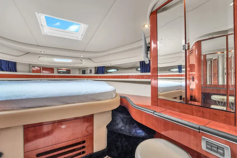 Slide: The Image of Luxurious cabin interior of 2004 Sea Ray 460 Sundancer yacht with skylight and wood finishes. - 23
