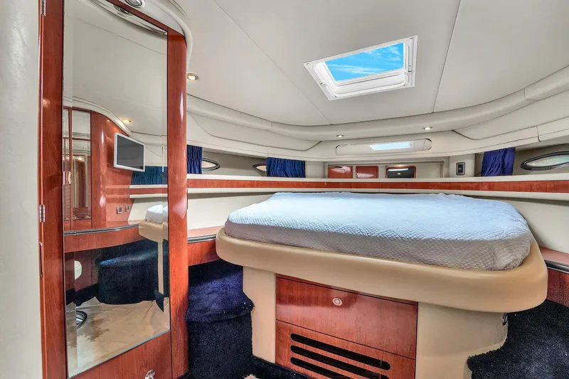 Slide: The Image of Luxurious cabin interior of 2004 Sea Ray 460 Sundancer yacht with skylight and wood finishes. - 24
