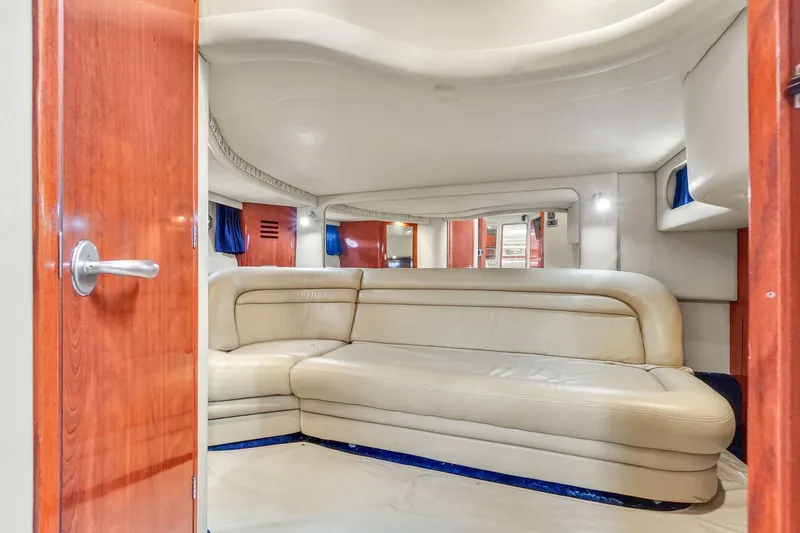Slide: The Image of 2004 Sea Ray 460 Sundancer interior with cream leather seating and wooden accents. - 26