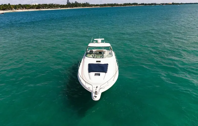 Slide: The Image of 2004 Sea Ray 460 Sundancer yacht on clear turquoise water, aerial view. - 3