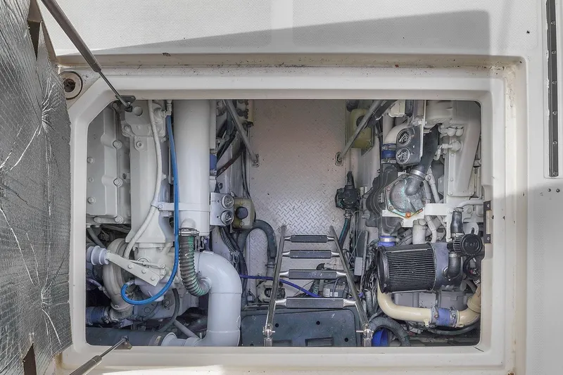 Slide: The Image of Engine compartment of 2004 Sea Ray 460 Sundancer, showcasing mechanical components and systems. - 30