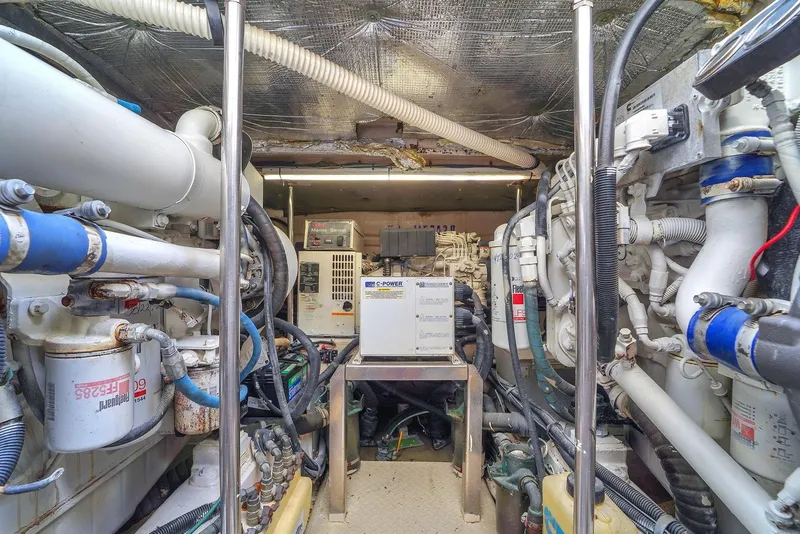 Slide: The Image of Engine room of a 2004 Sea Ray 460 Sundancer with mechanical equipment and piping. - 31