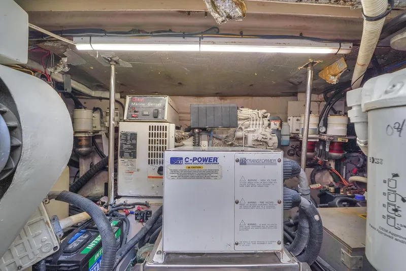 Slide: The Image of Engine room of 2004 Sea Ray 460 Sundancer with generator and equipment. - 32