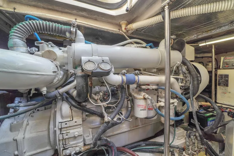 Slide: The Image of Engine room of a 2004 Sea Ray 460 Sundancer yacht, showcasing complex machinery and components. - 34