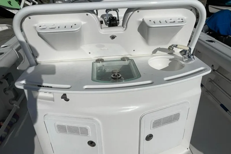 Slide: The Image of 2008 Everglades 290 Center Console boat with sink and storage compartments. - 10