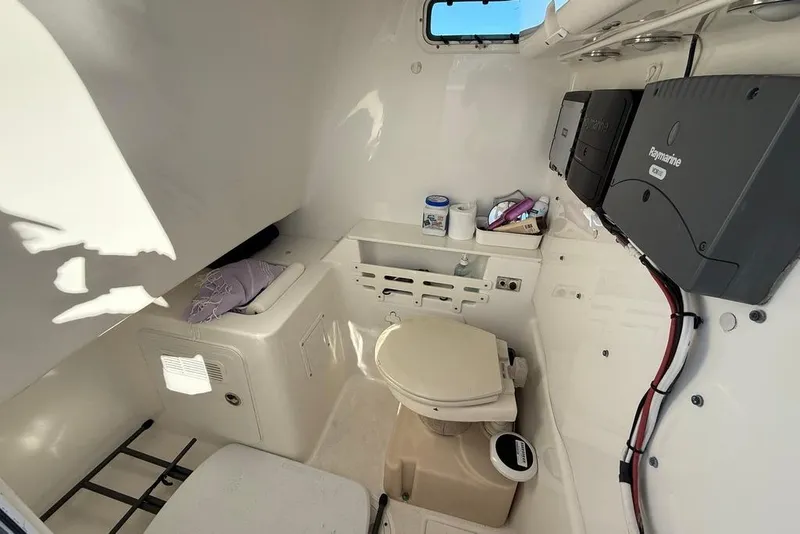 Slide: The Image of Interior of 2008 Everglades 290 Center Console boat with toilet and storage compartments. - 12