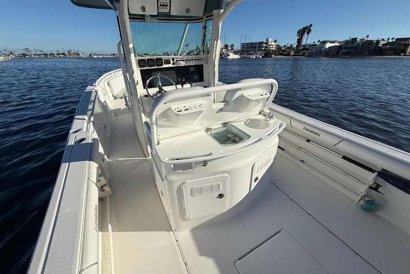 Slide: The Image of 2008 Everglades 290 Center Console boat on calm water, featuring a sleek design and spacious deck. - 5